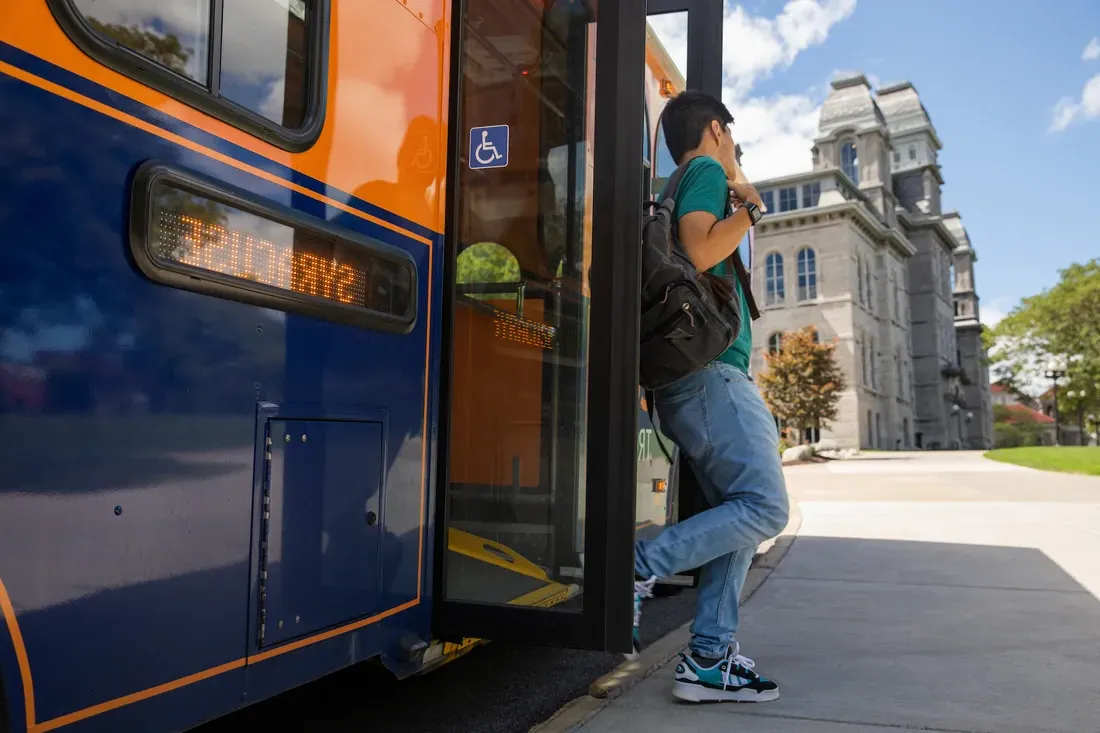 Student getting off the bus.